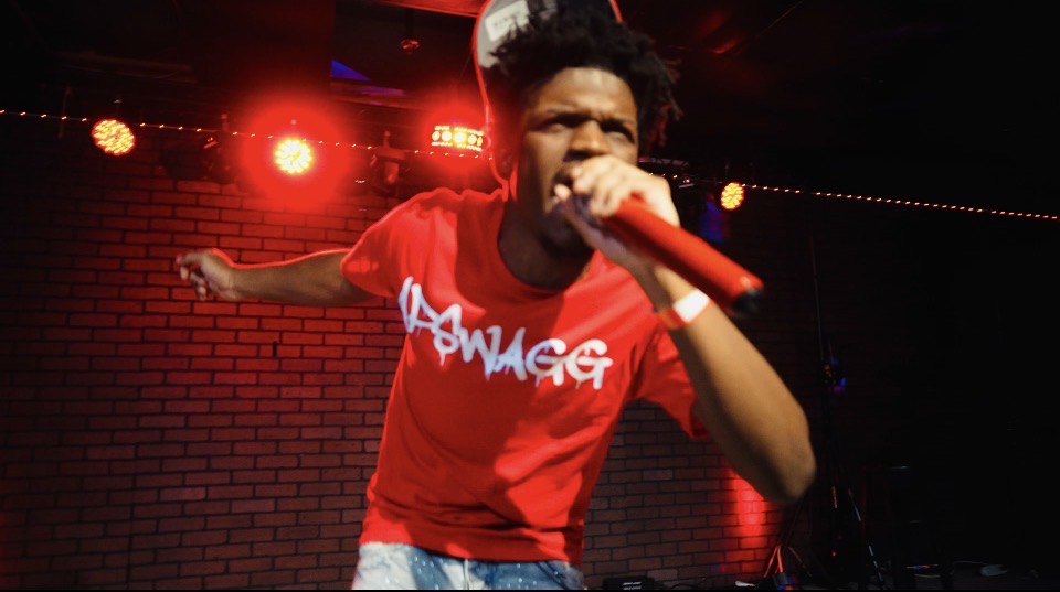 APSWAGG full-body live performance while holding a microphone
